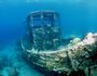 A wrecked tugboat lies encrusted with corals and barnacles at the bottom of Caracas Bay in  Curacao Underwater Park.