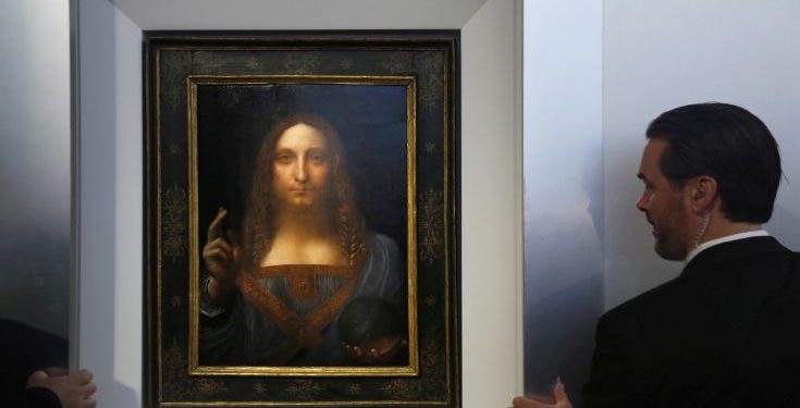 Security guards open a door to reveal "Salvator Mundi" by Leonardo da Vinci during a news conference at Christie's in New York, Tuesday, Oct. 10, 2017. The piece, which was painted around 1500, is one of fewer than twenty da Vinci paintings known to exist. After public exhibitions around the world, the auction is scheduled to take place on Nov. 15, 2017. (AP Photo/Seth Wenig)