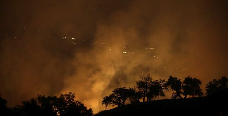 A wildfires creates an orange glow in a view from a hilltop Friday, Oct. 13, 2017, in Geyserville, Calif. (AP Photo/Marcio Jose Sanchez)