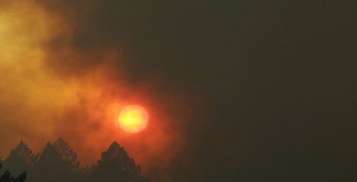 The sun shines through smoke and haze from wildfires over Santa Rosa, Calif., Tuesday, Oct. 10, 2017. (AP Photo/Jeff Chiu)