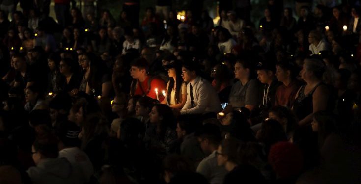 Students from University of Nevada Las Vegas hold a vigil Monday, Oct. 2, 2017, in Las Vegas. A gunman on the 32nd floor of the Mandalay Bay casino hotel rained automatic weapons fire down on the crowd of over 22,000 at an outdoor country music festival Sunday. (AP Photo/Gregory Bull)