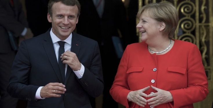 French president Emmanuel Macron, left, and German chancellor Angela Merkel meet ahead of the opening of the Frankfurt Book Fair in Frankfurt am Main, Germany, Tuesday, Oct. 10, 2017. France is this year's honorary guest. (Boris Roessler/dpa via AP)