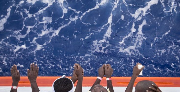 African migrants stand on the deck of the Aquarius vessel of "SOS Mediterranee" and MSF (Doctors Without Borders) NGOs, in the Mediterranean Sea, southwest of Malta, Thursday, Aug. 31, 2017. 265 people rescued from the sea during previous days are being transferred to Italy. (AP Photo/Darko Bandic)