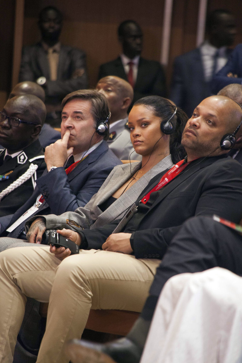 Singer Rihanna, center, looks on during a meeting in Dakar, Senegal, Friday, Feb. 2, 2018. Singer Rihanna and French President Emmanuel Macron were headlining a meeting in Senegal on Friday raising money for education in poor countries. Cheers and whistles rang out in the conference center in Senegal's capital, Dakar, as Rihanna was announced. (AP Photo/Mamadou Diop)
