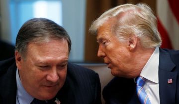 President Trump whispers to U.S. Secretary of State Pompeo during cabinet meeting at the White House in Washington