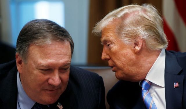 President Trump whispers to U.S. Secretary of State Pompeo during cabinet meeting at the White House in Washington
