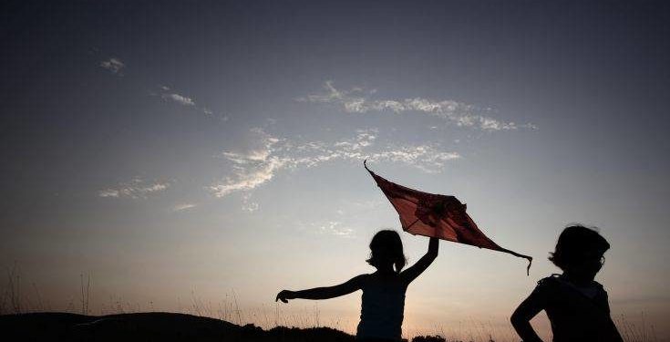 Children fly a kite at sunset near the Black Sea village of Varvara some 450 kms (280 miles) south east of the Bulgaria capital Sofia, Thursday, Aug. 18, 2011. (AP Photo/Valentna Petrova)
