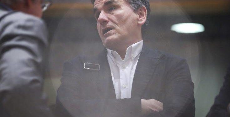 Greek Finance Minister Euclid Tsakalotos arrives to the Eurogroup Finance Ministers meeting at the European Council headquarters in Brussels, Monday, March 11, 2019. (AP Photo/Francisco Seco)