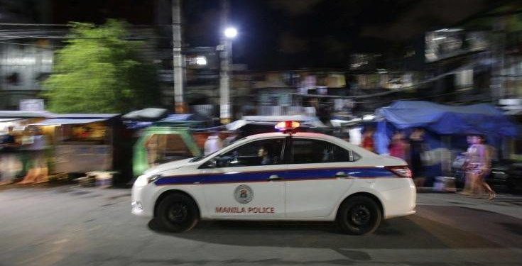 In this Wednesday June 8, 2016 photo, a Filipino police car passes by a village as they enforce a night to dawn curfew for minors in Manila, Philippines. In a crackdown, dubbed “Oplan Rody," bearing Duterte’s name, police rounded up hundreds of children or their parents to enforce a night curfew for minors, and taken away drunk and shirtless men roaming metropolitan Manila's slums. The poor, who were among Duterte’s strongest supporters, are getting a foretaste of the war against crime he has vowed to wage. (AP Photo/Aaron Favila)