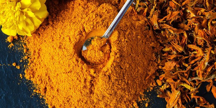 Turmeric powder over slate background