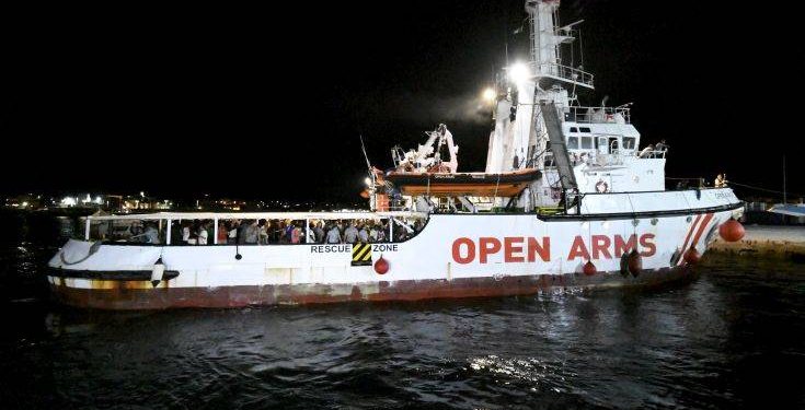 The Open Arms rescue ship arrives on the Sicilian island of Lampedusa, southern Italy, Tuesday, Aug. 20, 2019. An Italian prosecutor ordered the seizure of a rescue ship and the immediate evacuation of more than 80 migrants still aboard, capping a drama Tuesday that saw 15 people jump overboard in a desperate bid to escape deteriorating conditions on the vessel and Spain dispatch a naval ship to try to resolve the crisis. (AP Photo/Salvatore Cavalli)