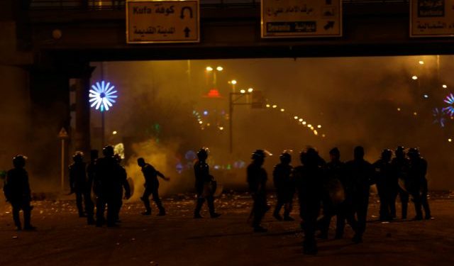 Members of riot police are seen during ongoing anti-government protests in Najaf