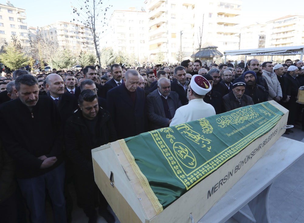 Turkey's President Recep Tayyip Erdogan, centre, attends a funeral procession for Salih Civelek and Aysegul Civelek, victims of Friday's earthquake in Elazig, eastern Turkey, Friday, during the Saturday, Jan. 25, 2020.  Rescuers continued searching for people buried under the rubble of collapsed buildings while emergency workers and security forces distributed tents, beds and blankets in the affected areas. Mosques, schools, sports halls and student dormitories were opened for hundreds who left their homes after the quake. (Presidential Press Service via AP, Pool)