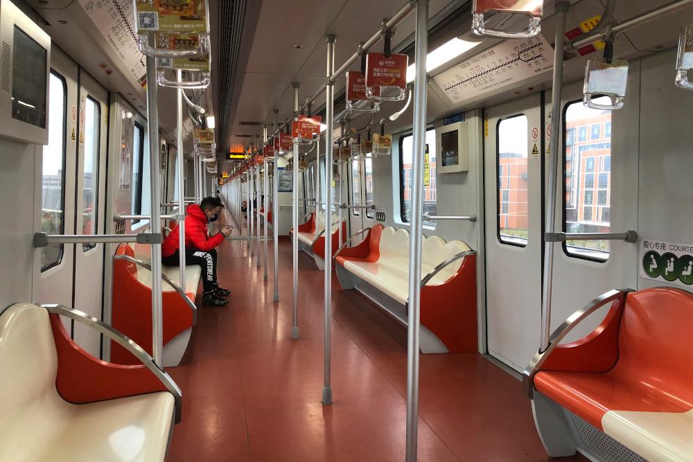 A man wears a face mask as he rides a nearly empty subway train near the Shanghai Disney Resort, which announced that it will be closed indefinitely from Saturday, in Shanghai, Saturday, Jan. 25, 2020. China's most festive holiday began in the shadow of a worrying new virus Saturday as the death toll surpassed 40, an unprecedented lockdown that kept people from traveling was expanded to more than 50 million residents and authorities canceled a host of Lunar New Year events. (AP Photo/Fu Ting)