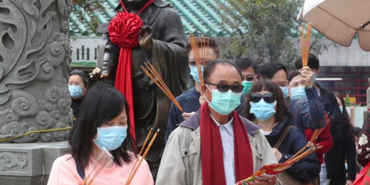 People wear masks as they pray at the Wong Tai Sin Temple, in Hong Kong, Saturday, Jan. 25, 2020 to celebrate the Lunar New Year which marks the Year of the Rat in the Chinese zodiac. China's most festive holiday began in the shadow of a worrying new virus Saturday as the death toll surpassed 40, an unprecedented lockdown kept 36 million people from traveling and authorities canceled a host of Lunar New Year events. (AP Photo/Achmad Ibrahim)