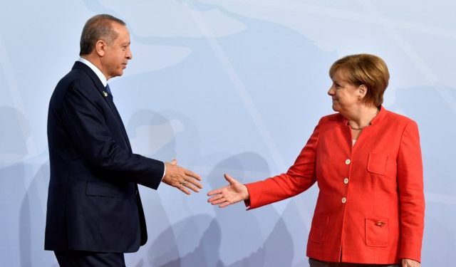 FILE PHOTO: German Chancellor Angela Merkel greets Turkey's President Recep Tayyip Erdogan at the beginning of the G20 summit in Hamburg, Germany, July 7, 2017. REUTERS/John MACDOUGALL/POOL/File Photo