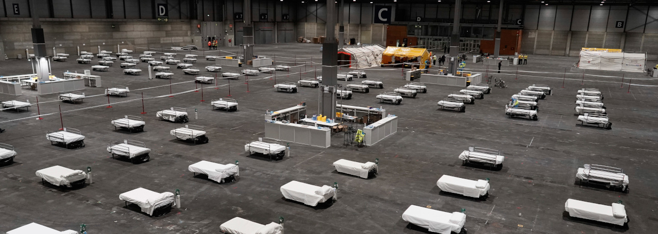 In this photo provided by Comunidad de Madrid, beds for COVID-19 patients are placed at IFEMA convention center in Madrid, Spain on Saturday, March 21, 2020. Spanish health authorities have acknowledged that some intensive care units in the hardest-hit areas are close to their limit. The army was building a field hospital with 5,500 beds in a convention center in Madrid, where hotels are also being turned into wards for virus patients without serious breathing problems. (Comunidad de Madrid via AP)