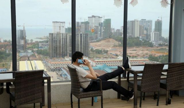 A man speaks on his phone on the rooftop of Chinese businessman Kang Quiang's casino Dong Yuan, in Sihanoukville, Cambodia, February 28, 2020. REUTERS/Jorge Silva SEARCH "COVID-19 CAMBODIA CASINOS" FOR THIS STORY. SEARCH "WIDER IMAGE" FOR ALL STORIES.