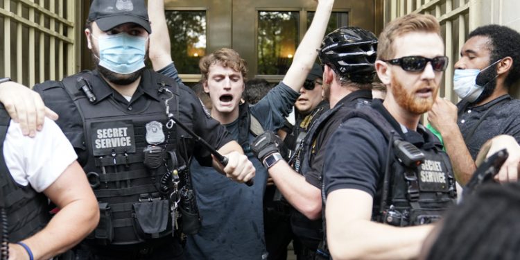 Demonstrators protest the death of George Floyd, a black man who died in police custody in Minneapolis, Friday, May 29, 2020, in Washington, near the White House Minority Leader Kevin McCarthy of Calif.,. (AP Photo/Evan Vucci)