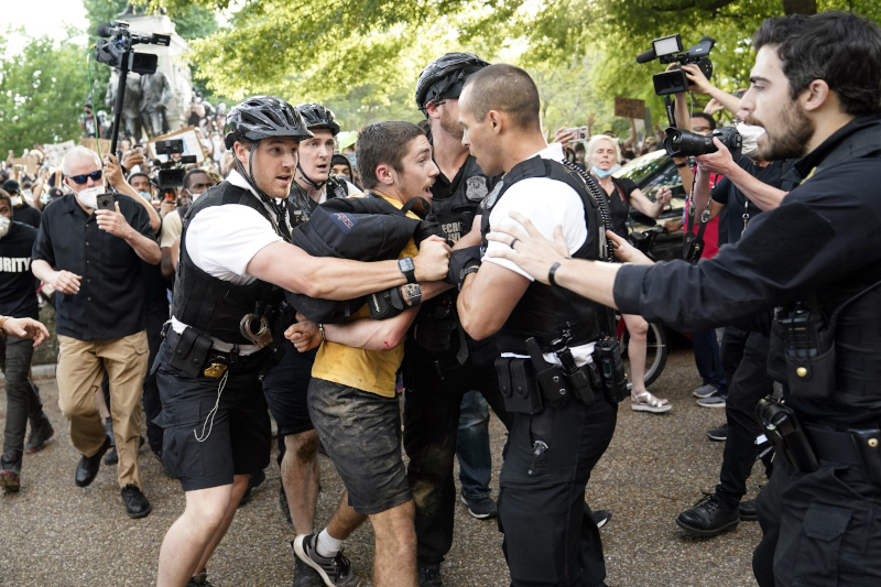 Uniformed U.S. Secret Service police detain a protester in Lafayette Park across from the White House as demonstrators protest the death of George Floyd, a black man who died in police custody in Minneapolis, Friday, May 29, 2020, in Washington. (AP Photo/Evan Vucci)