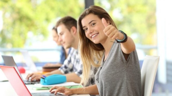 happy-student-with-thumbs-up-in-a-classroom-picture-id820889590-666x399