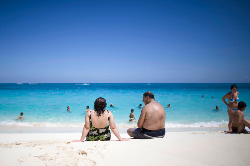 Tourists sunbathe along the beach in Nassau, Bahamas, Saturday, Sept. 6, 2008.  Caribbean tourism officials are working overtime to reassure reluctant travelers that plenty of sun-soaked islands were untouched by a recent spate of deadly tropical cyclones. (AP Photo/Alexandre Meneghini)