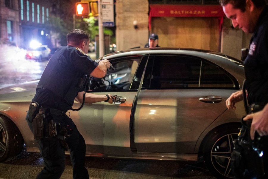 Police stop a driver at gunpoint after he was swerving onto the sidewalks in the SoHo shopping district of New York following a rally to protest police brutality Sunday, May 31, 2020. Protests were held throughout the city, sparked by the death of George Floyd, a black man who was killed after he was pinned at the neck by a Minneapolis police officer on May 25. (AP Photo/Wong Maye-E)