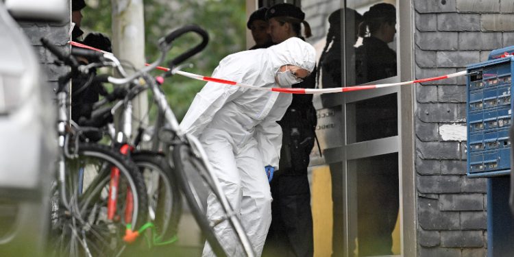 A forensic officer leaves a house, where five dead children were found in Solingen, Germany, Thursday, Sept. 3, 2020. Police say the five children have been found dead at an apartment in the western German city, and their mother is suspected of killing them. (AP Photo/Martin Meissner)