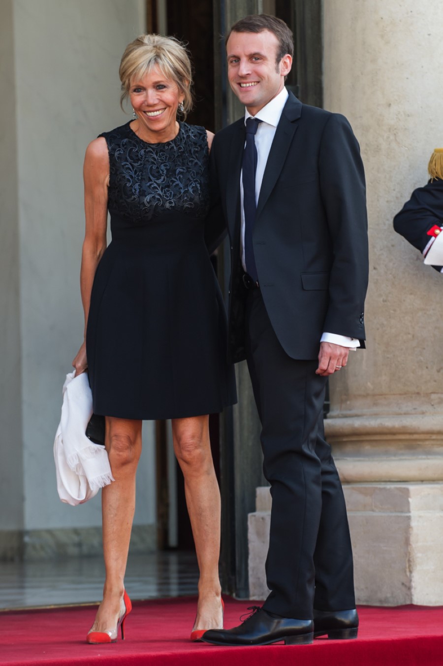 France's Economy Minister Emmanuel Macron and his wife Brigitte Trogneux pose for photographers as they arrive at the Elysee Palace in Paris, France, Tuesday, June 2, 2015. (AP Photo/Kamil Zihnioglu)