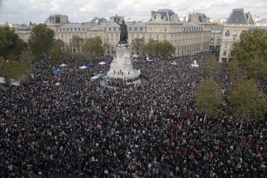Hundreds of people gather on Republique square during a demonstration Sunday Oct. 18, 2020 in Paris. Demonstrations around France have been called in support of freedom of speech and to pay tribute to a French history teacher who was beheaded near Paris after discussing caricatures of Islam's Prophet Muhammad with his class. Samuel Paty was beheaded on Friday by a 18-year-old Moscow-born Chechen refugee who was shot dead by police. (AP Photo/Michel Euler)