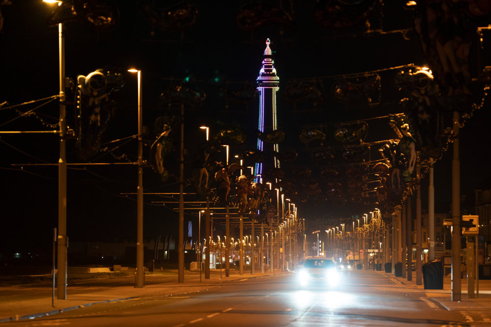 Blackpool Tower stands lit alone following the town's annual Illuminations being switched off at midnight on Wednesday because of the four-week lockdown, in Blackpool, England, Thursday Nov. 5, 2020. The illuminations were due to remain lit for an extra two months this season, until Jan. 3, to aid the town's tourism trade hit by COVID-19 restrictions. ( AP Photo/Jon Super)