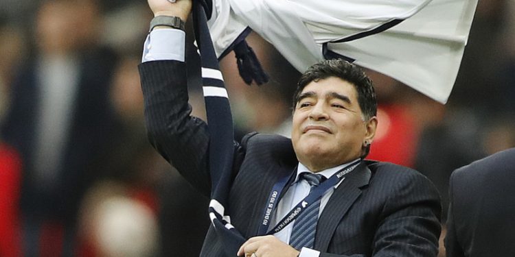 Argentina soccer legend Diego Armando Maradona waves a shirt during halftime of the English Premier League soccer match between Tottenham Hotspur and Liverpool at Wembley Stadium in London, Sunday, Oct. 22, 2017.(AP Photo/Frank Augstein)