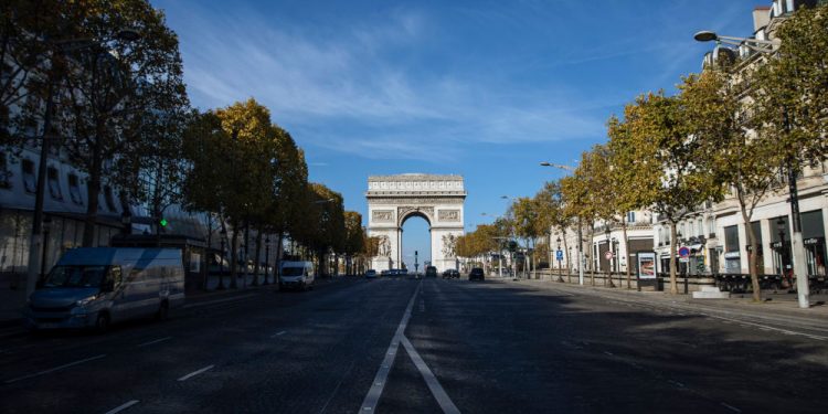 An almost empty Champs Elysees avenue in Paris, Saturday, Oct. 31, 2020. France re-imposed a monthlong nationwide lockdown Friday aimed at slowing the spread of the virus, closing all non-essential business and forbidding people from going beyond one kilometer from their homes except to go to school or a few other essential reasons. (AP Photo/Lewis Joly)