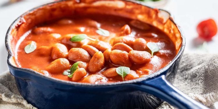 Hot baked beans with garlic and fresh tomatoes