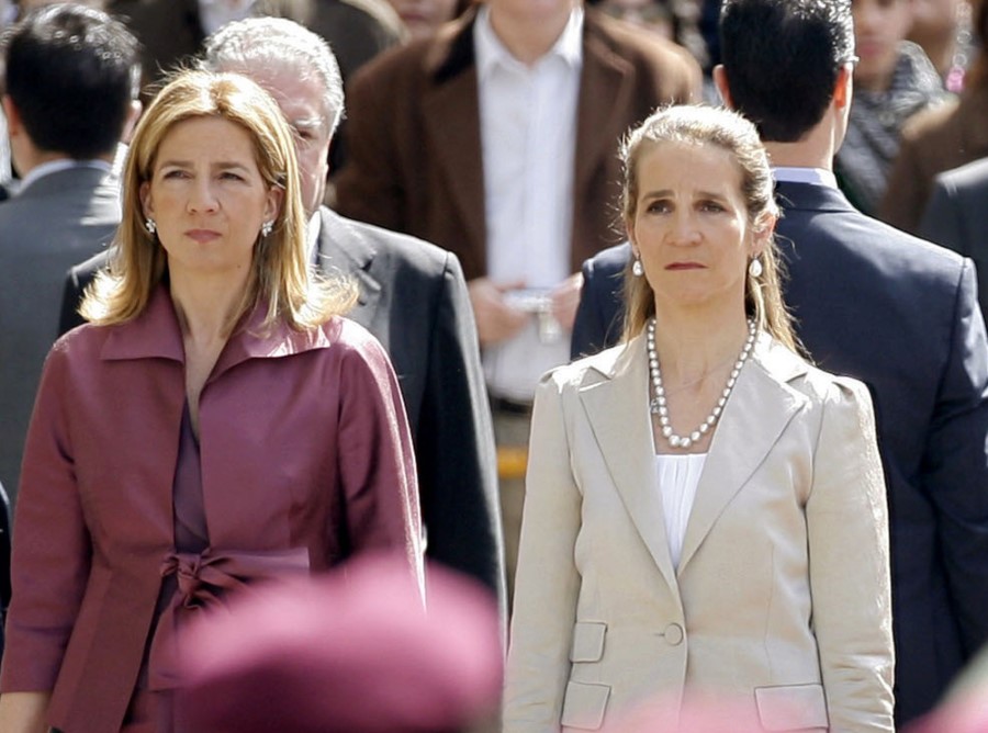 FILE - In this Wednesdday, April 16, 2008 file photo, Spain's Princess Cristina, left and Princess Elena, listen to the Spanish national anthem during a ceremony, upon their arrival for the opening of the Spanish Parliament, after Jose Luis Rodriguez Zapatero's Socialist Party won the general elections on March 9, in Madrid. The sisters of Spanish King Felipe VI have acknowledged on Wednesday, March 3, 2021, that they were administered COVID-19 vaccines during a visit to the United Arab Emirates. In a statement published by a Spanish newspaper, the Infantas Elena and Cristina said that they were “offered the possibility” of receiving vaccines while in Abu Dhabi to visit their father and former monarch, Juan Carlos I.  (AP Photo/Daniel Ochoa de Olza, File)