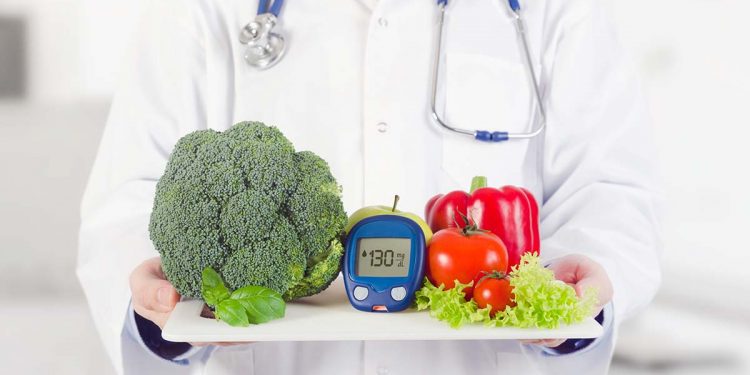 Doctor holding vegetables and fruits on a tray