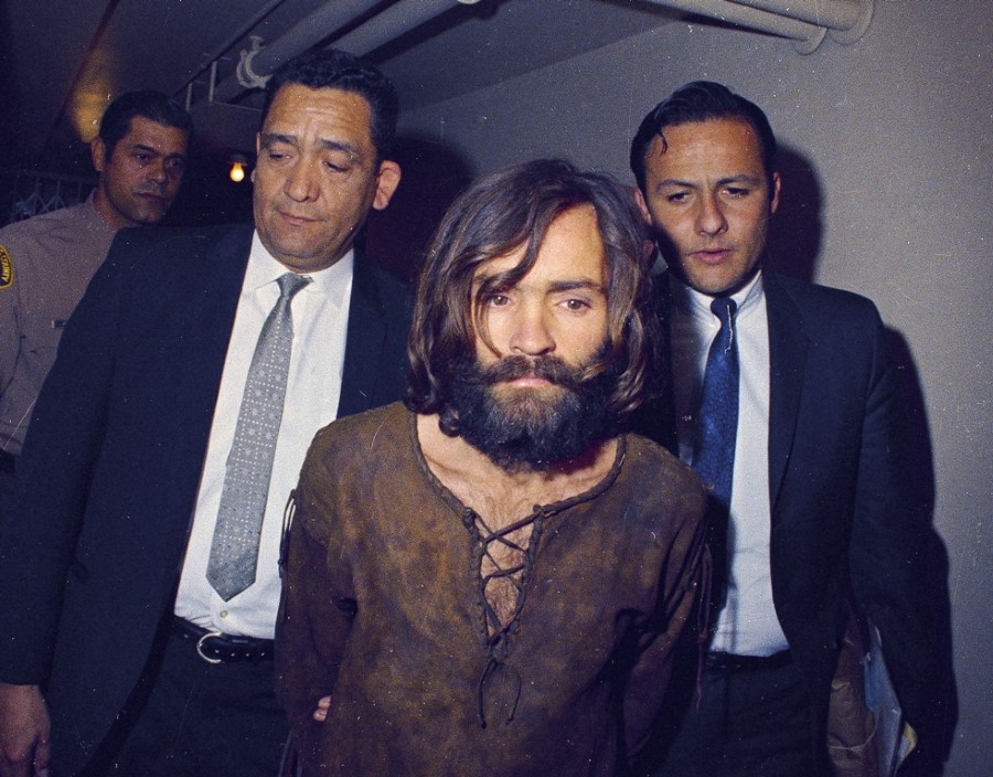 FILE  This 1969 file photo shows Charles Manson being escorted to his arraignment on conspiracy-murder charges in connection with the Sharon Tate murder case  Los Angeles, Calif. Mass murderer Anders Behring Breivik's shocking testimony to a Norwegian court has revived a debate about how much of a public platform mass-murderers should be given in trials. Such atrocities are often waged for attention and carried out in the name of political or religious goals, and a trial gives perpetrators more of what they crave: a huge audience.  Cult leader Charles Manson, who persuaded others to kill for him, refused to testify in the raucous 1970 trial of him and other members of his "Manson Family." In an unusual proceeding, Manson was allowed to testify outside the jury's presence so that the judge could rule on whether his testimony was admissible in front of jurors.(AP Photo)