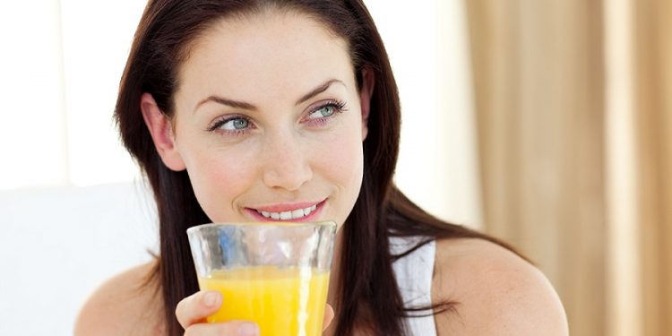 Attractive woman drinking orange juice
