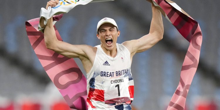 Joseph Choong of Britain crosses the finish line to win the men's modern pentathlon at the 2020 Summer Olympics, Saturday, Aug. 7, 2021, in Tokyo, Japan. (AP Photo/Andrew Medichini)