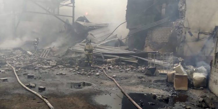 In this photo released by Russian Emergency Ministry Press Service, emergency personnel work at the site of an explosion and fire at a gunpowder factory in the Ryazan region, about 270 kilometers (about 167 miles) southeast of Moscow, Russia, Friday, Oct. 22, 2021. Russian emergency officials say that at least seven people have died and a further nine are missing following an explosion and fire at a gunpowder factory.  (Ministry of Emergency Situations press service via AP)