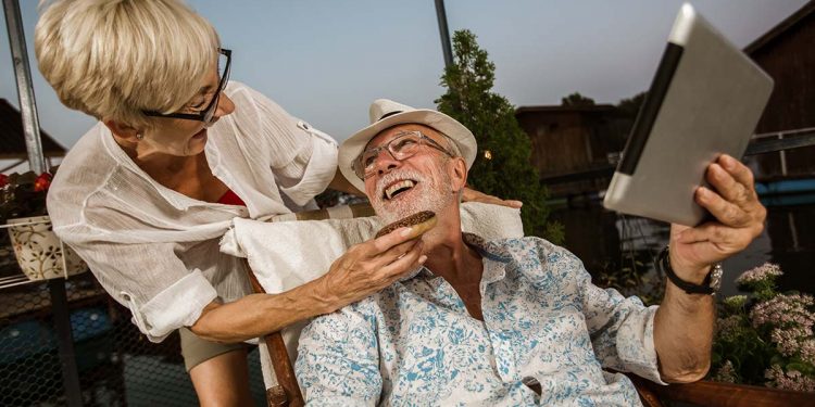 Senior couple enjoying a evening in the cottage near the river,