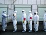 Volunteers in protective suits are being disinfected in a line in Wuhan, the epicentre of the novel coronavirus outbreak, in Hubei