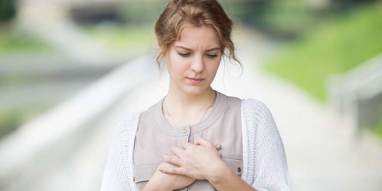 Portrait of stressed or lonely woman with heart ache outdoors