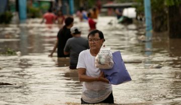 A man carries food he saved from his flooded home after Super Typhoon Noru, in San Miguel, Bulacan province, Philippines, September 26, 2022. REUTERS/Eloisa Lopez