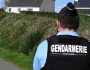 A french gendarme stands guard on a road next to a house where four people have been found dead, in Carantec, western France on october 30, 2022. - A man, a woman and two young girls from the same family were found dead on October 30, 2022 in a house in Carantec, near Morlaix, western France. (Photo by DAMIEN MEYER / AFP)