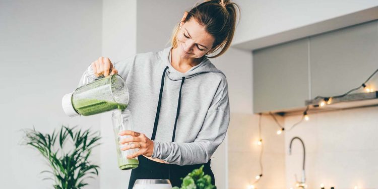 Young,Woman,Making,Detox,Smoothie,At,Home.,Woman,Pouring,Smoothie