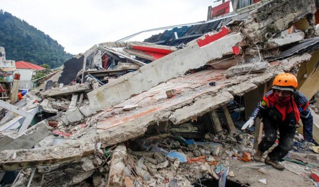 A rescuer walks among the rubble of collapsed buildings during a rescue operation after earthquake hit in Cianjur, West Java province, Indonesia, November 22, 2022, in this photo taken by Antara Foto. Antara Foto/Yulius Satria Wijaya/ via REUTERS ATTENTION EDITORS - THIS IMAGE HAS BEEN SUPPLIED BY A THIRD PARTY. MANDATORY CREDIT. INDONESIA OUT. NO COMMERCIAL OR EDITORIAL SALES IN INDONESIA.