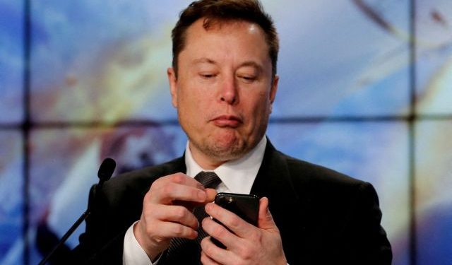 FILE PHOTO: Elon Musk looks at his mobile phone in Cape Canaveral, Florida, U.S. January 19, 2020. REUTERS/Joe Skipper//File Photo