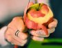 Close-up,Of,Hands,Peeling,An,Apple.,Woman's,Hands,Removes,The
