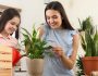 Mother and daughter taking care of plant at home